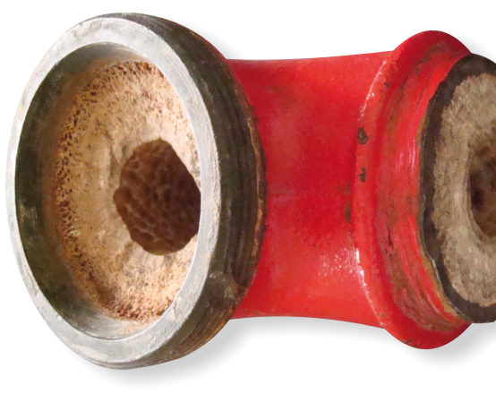 mineral scale inside red pipe fitting residential remove